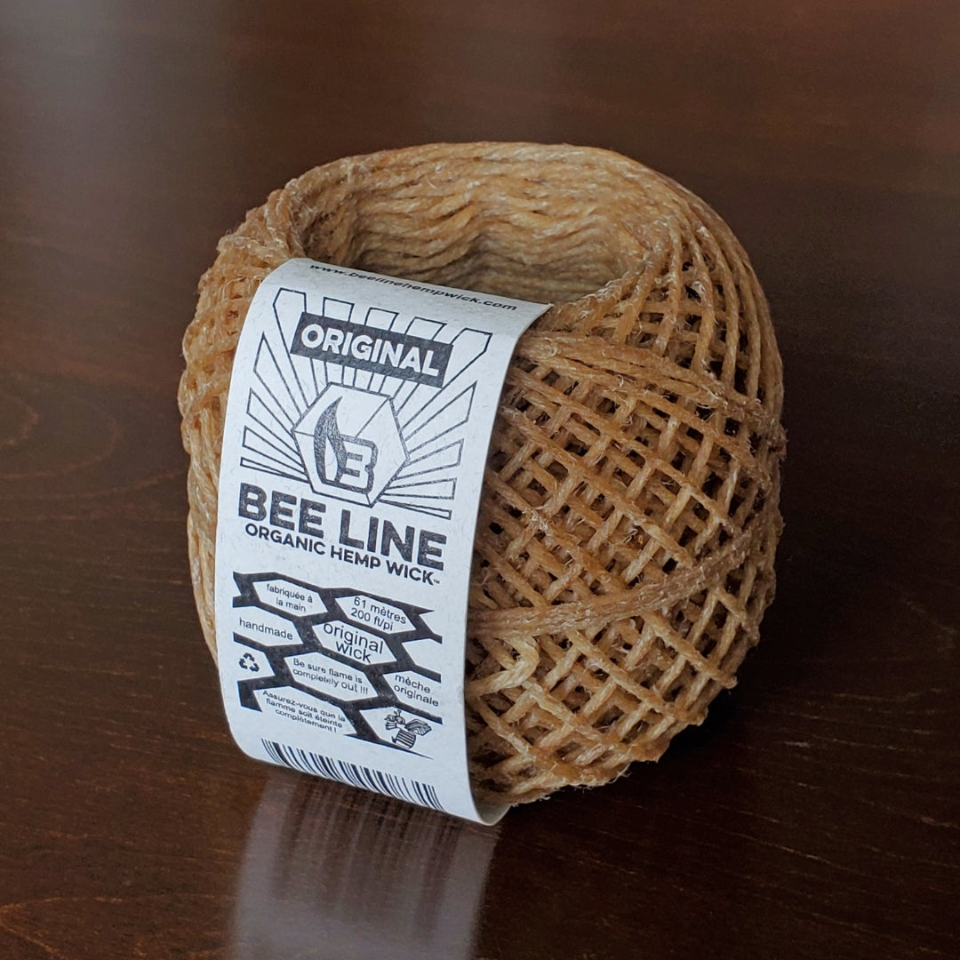 Ball of brown hemp wick with a label on a wooden surface
