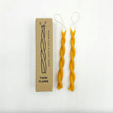 Twisted beeswax candles with a cardboard box labeled 'Twin Flame' on a white background