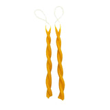 Two beeswax candles twisted around each other on a white background