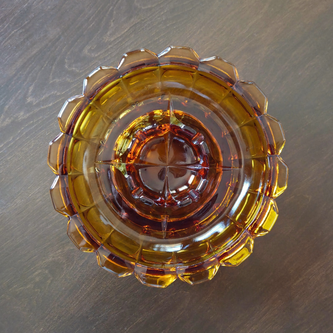 Decorative glass bowl with a geometric design on a wooden surface