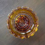 Decorative glass bowl with a geometric design on a wooden surface