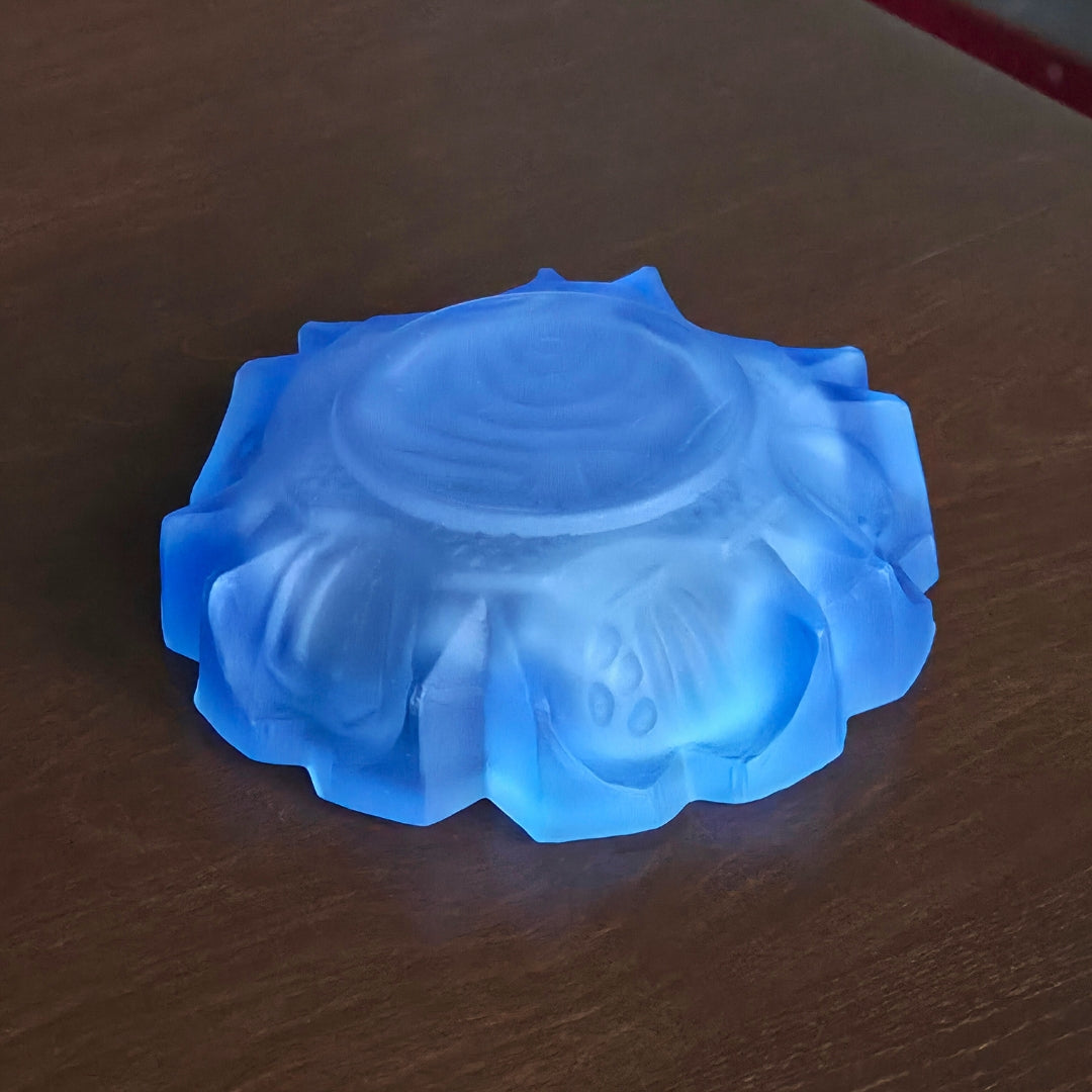 bottom of a blue glass ashtray