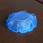 bottom of a blue glass ashtray