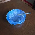 frosted blue rose ashtray with a clove cigarette