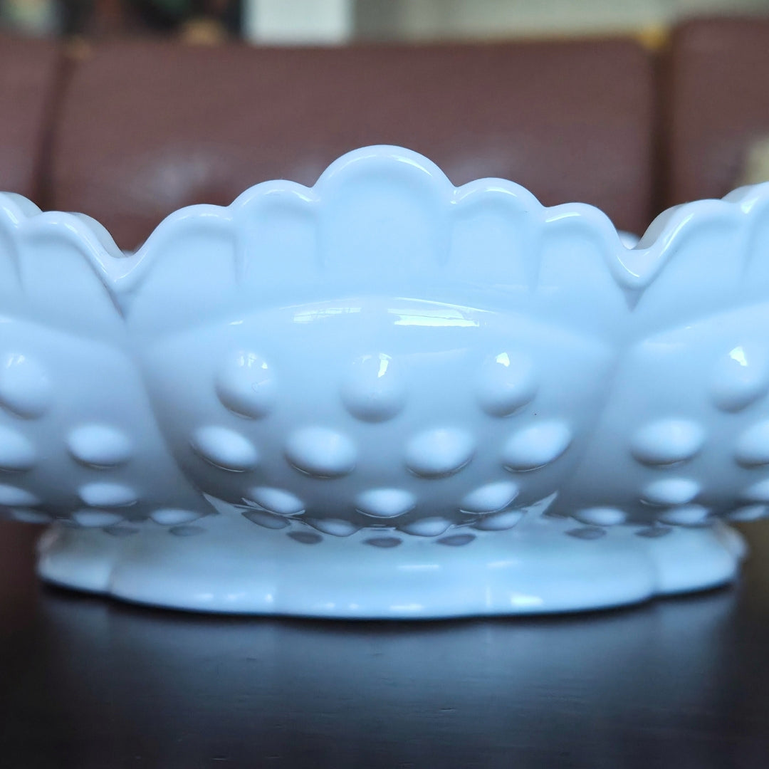 White ceramic dish with textured surface on a dark surface